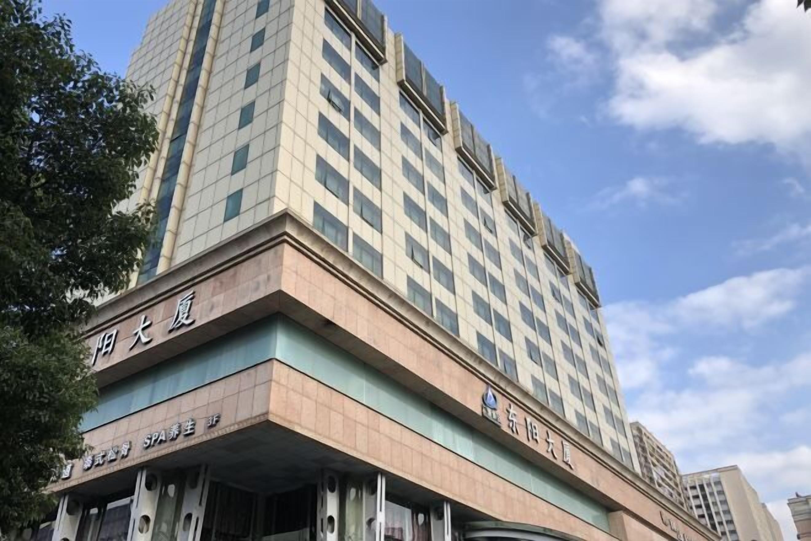 A multi-story building with a prominent sign indicating it is a hotel.