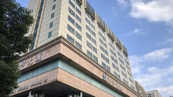 A multi-story building with a prominent sign indicating it is a hotel.
