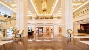 A spacious, multi-level lobby with a polished floor, a central chandelier, and a reception desk. - Dongyang Building (Dongyang Center Branch) (Dongyang)