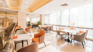 A spacious hotel lobby with a marble reception desk, modern seating areas, and large windows providing natural light. - Dongyang Building (Dongyang Center Branch) (Dongyang)