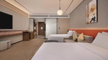 A modern hotel room with a large bed, a sofa, a TV, and a painting on the wall.