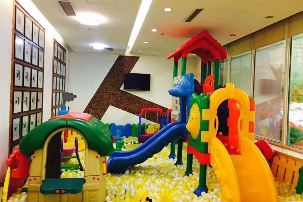 A children's play area with slides and climbing structures surrounded by a ball pit.