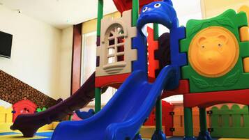 A children's play area with a slide and climbing structures.