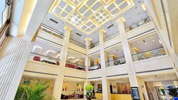 A multi-level atrium with a central open space, columns, and a decorative ceiling.