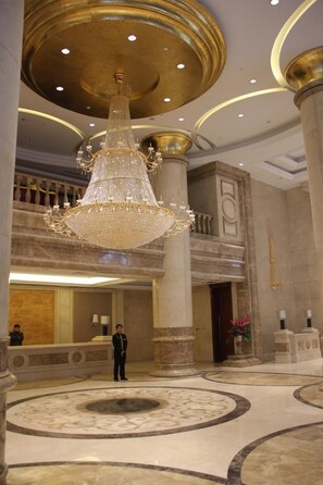 A grand lobby with a large chandelier, marble flooring, and classical architecture. - Fengcheng Hotel (Dandong)