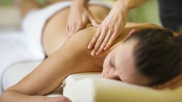 A person receiving a massage on a massage table.