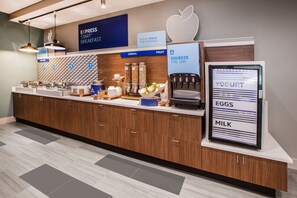 A modern breakfast bar with a coffee machine, cereal and fruit options, and a yogurt, eggs, and milk dispenser.