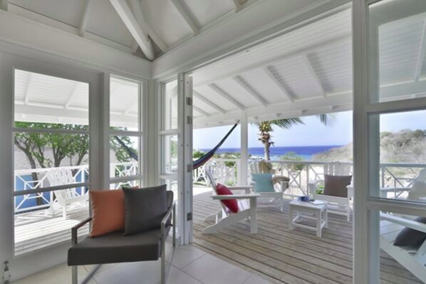 Bungalow, 3 Bedrooms | Living room | 32-inch flat-screen TV with digital channels, TV, books - Chogogo Dive & Beach Resort Curacao (Jan Thiel)