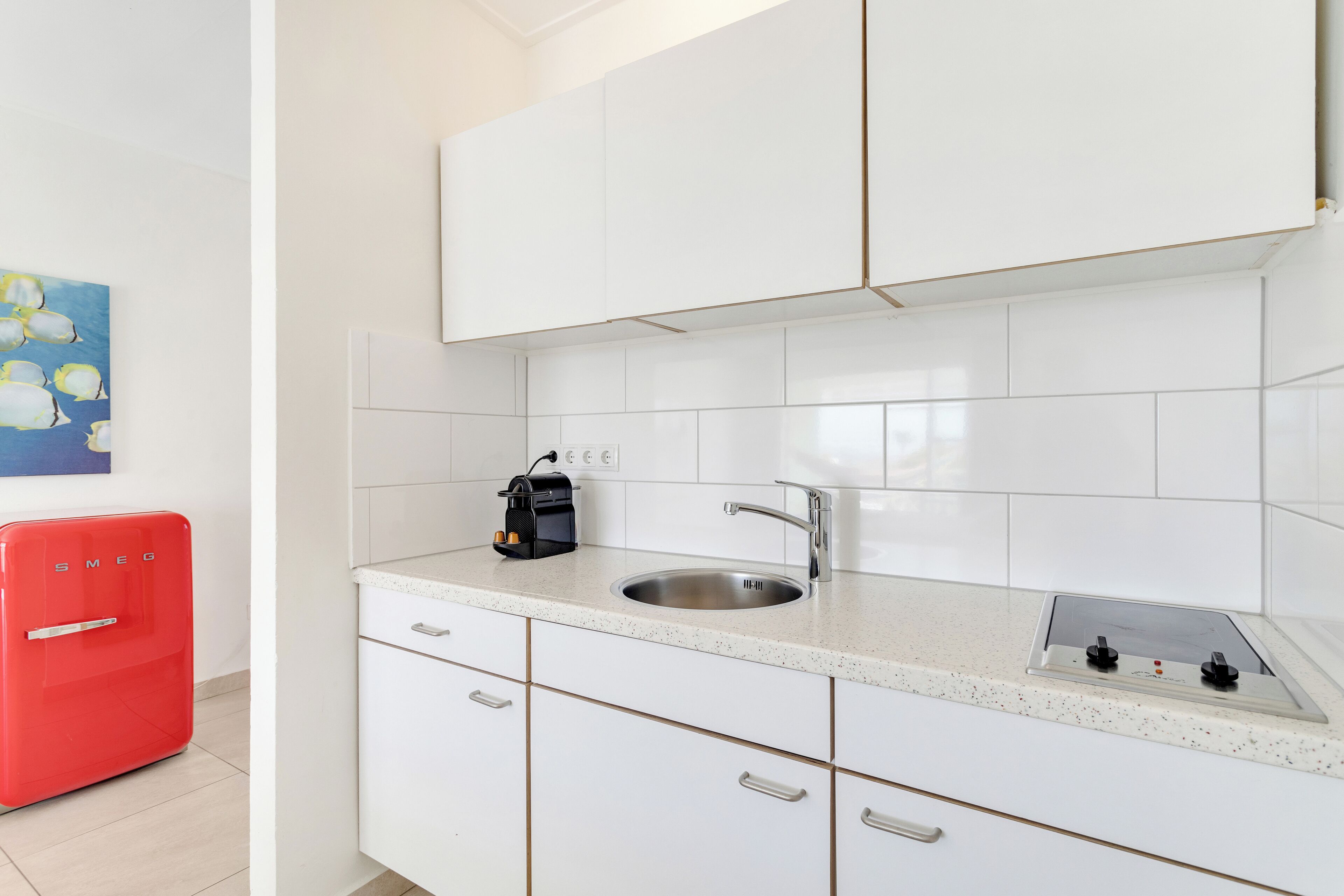 full-sized fridge, microwave, stovetop, coffee/tea maker