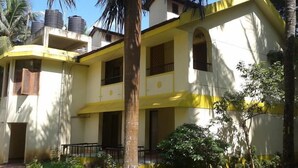 A two-story building with a yellow facade, multiple windows, and a small balcony. - Old Goa Residency (Panaji)