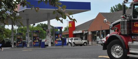 A gas station with a McDonald's and a fire truck parked nearby.