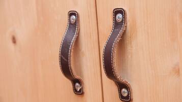 Two wooden door handles with metal screws.
