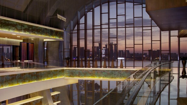 A modern interior with a glass atrium, a city skyline view, and a spacious, well-lit lobby area. - InterContinental Changsha by IHG (Changsha)