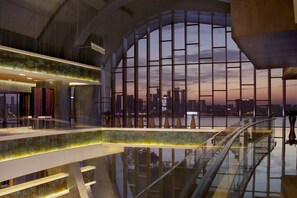A modern interior with a glass atrium, a city skyline view, and a spacious, well-lit lobby area. - InterContinental Changsha by IHG (Changsha)