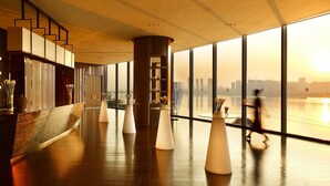 A modern interior with a large window overlooking a cityscape. - InterContinental Changsha by IHG (Changsha)
