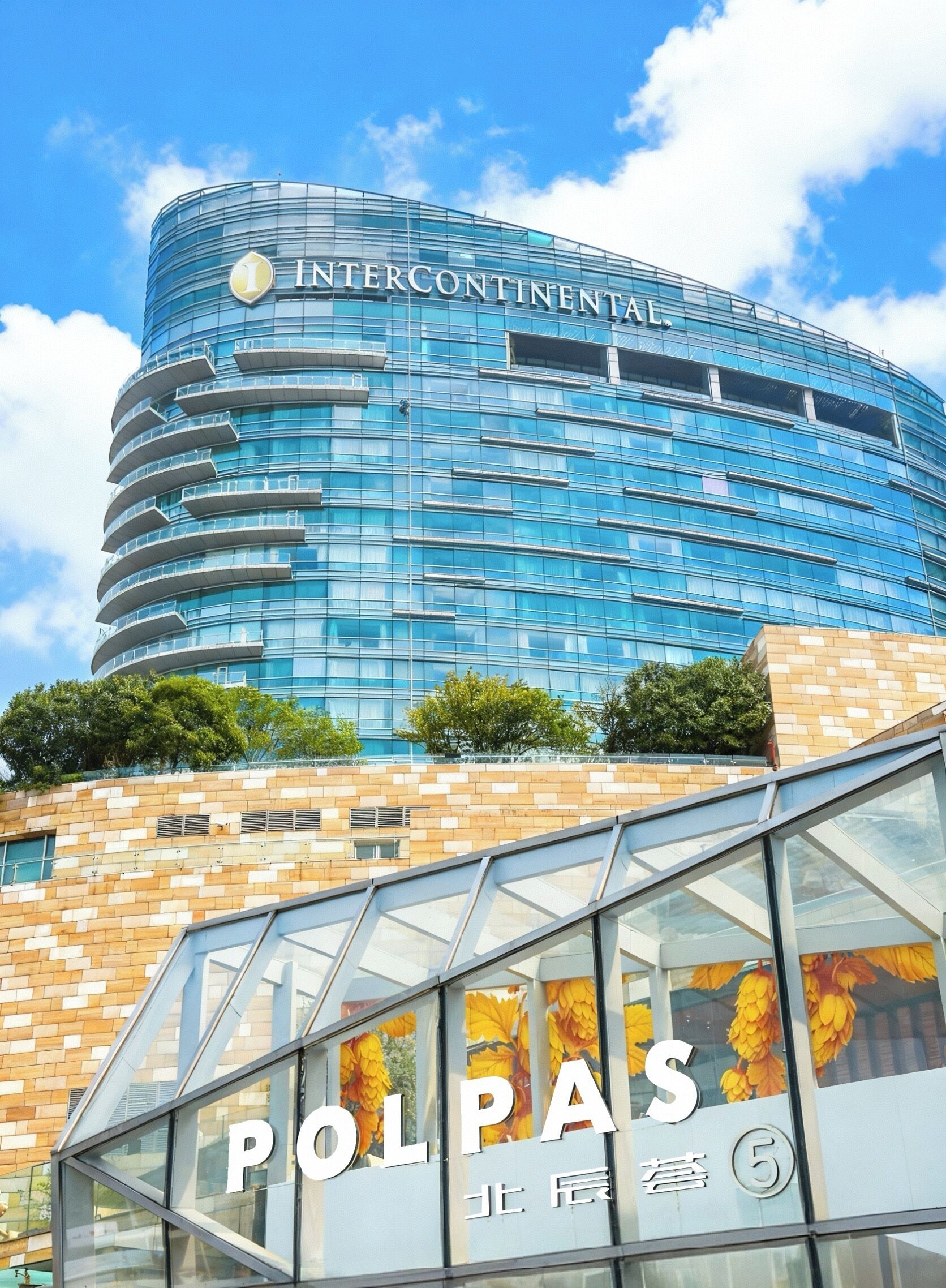 A modern building with a curved glass facade and the name 'INTERCONTINENTAL' prominently displayed.