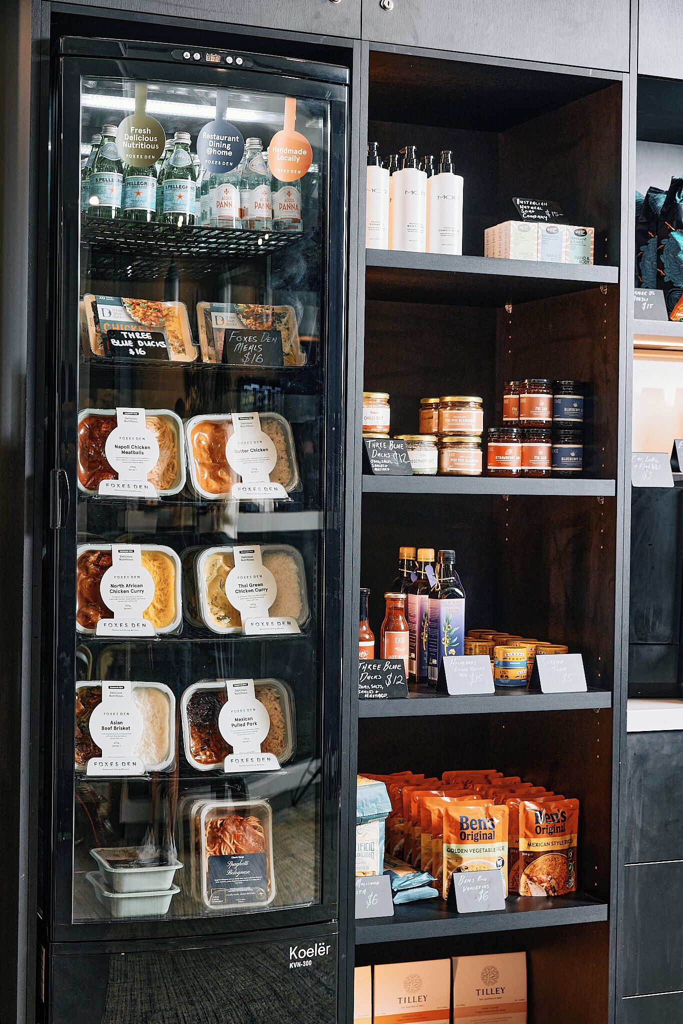 A refrigerated display case with various food items and condiments.