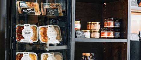 A refrigerated display case with various food items and condiments.