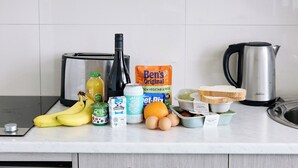 A kitchen counter with various food items and kitchen appliances. - Quest Melbourne Airport (Melbourne Airport)