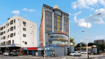 A multi-story building with a prominent entrance and signage.
