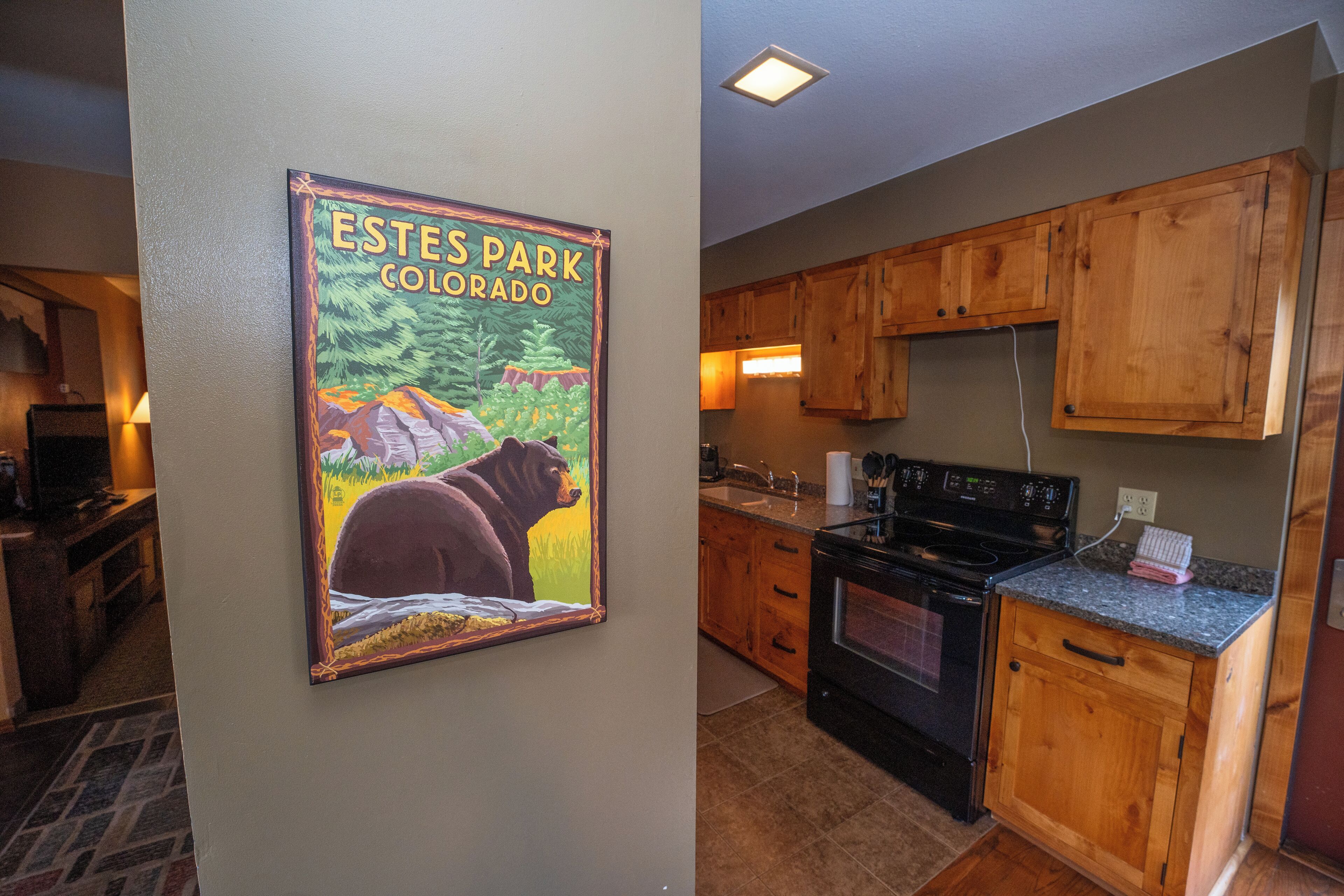 A kitchen with wooden cabinets, a stove, and a countertop.