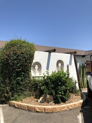 A building with arched windows and a cactus garden.