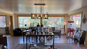 A cozy living room with a coffee bar, a sofa, and a rug.