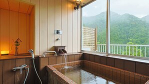 A wooden cabin with a large window overlooking a forested mountain. - Hinotanionsen Misugi Resort (Tsu)