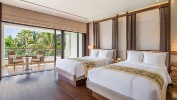 A hotel room with two beds, a balcony with a table and chairs, and a view of palm trees.