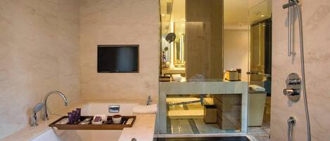 A modern bathroom with a bathtub, a glass-enclosed shower area, and a vanity with a mirror.