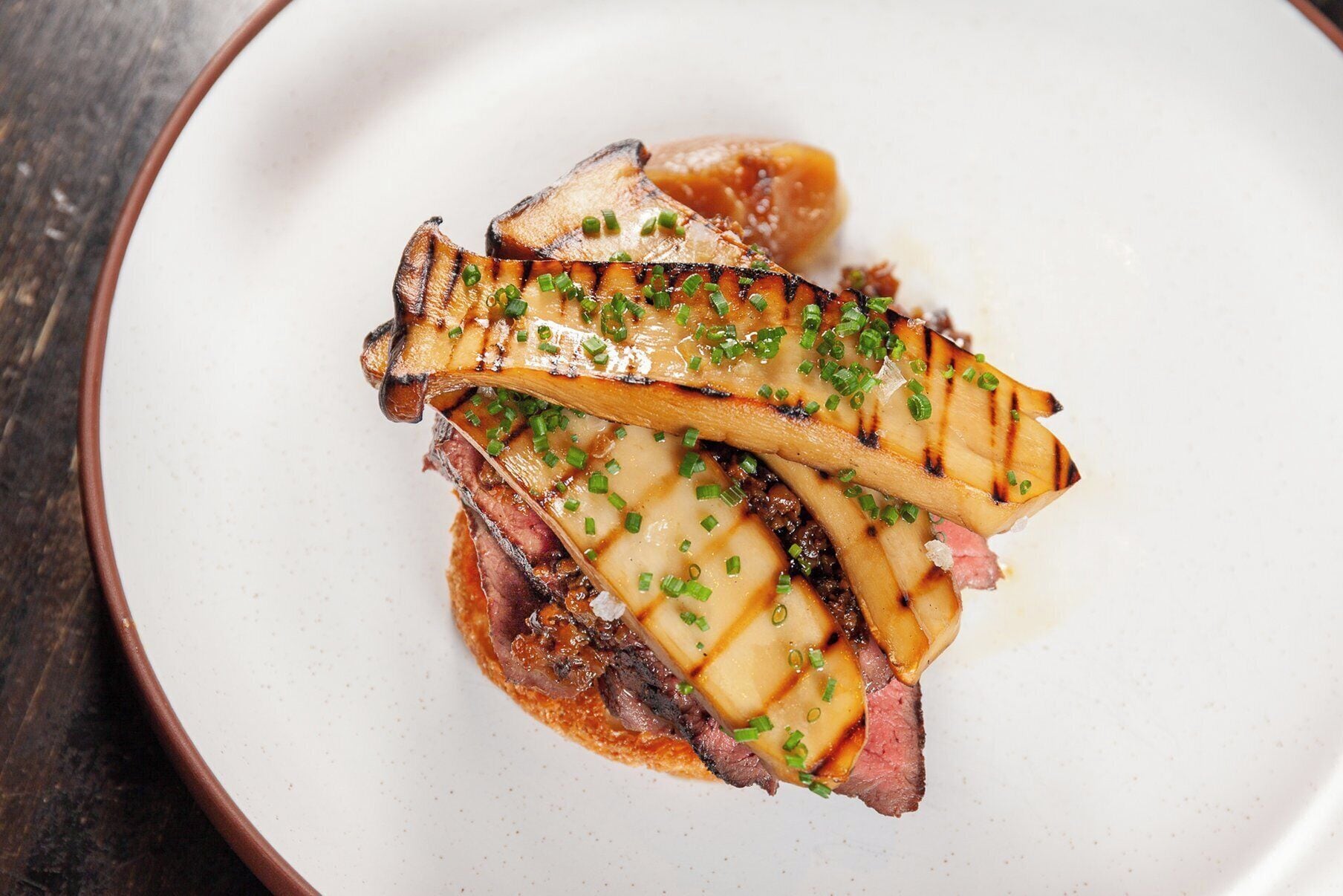 A plate with grilled meat and vegetables.