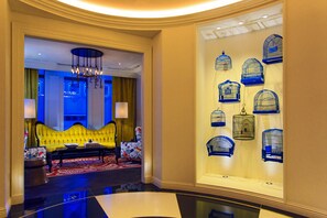 A lobby with a yellow sofa, a chandelier, and birdcage decorations. - Kimpton Hotel Monaco Pittsburgh by IHG (Pittsburgh)