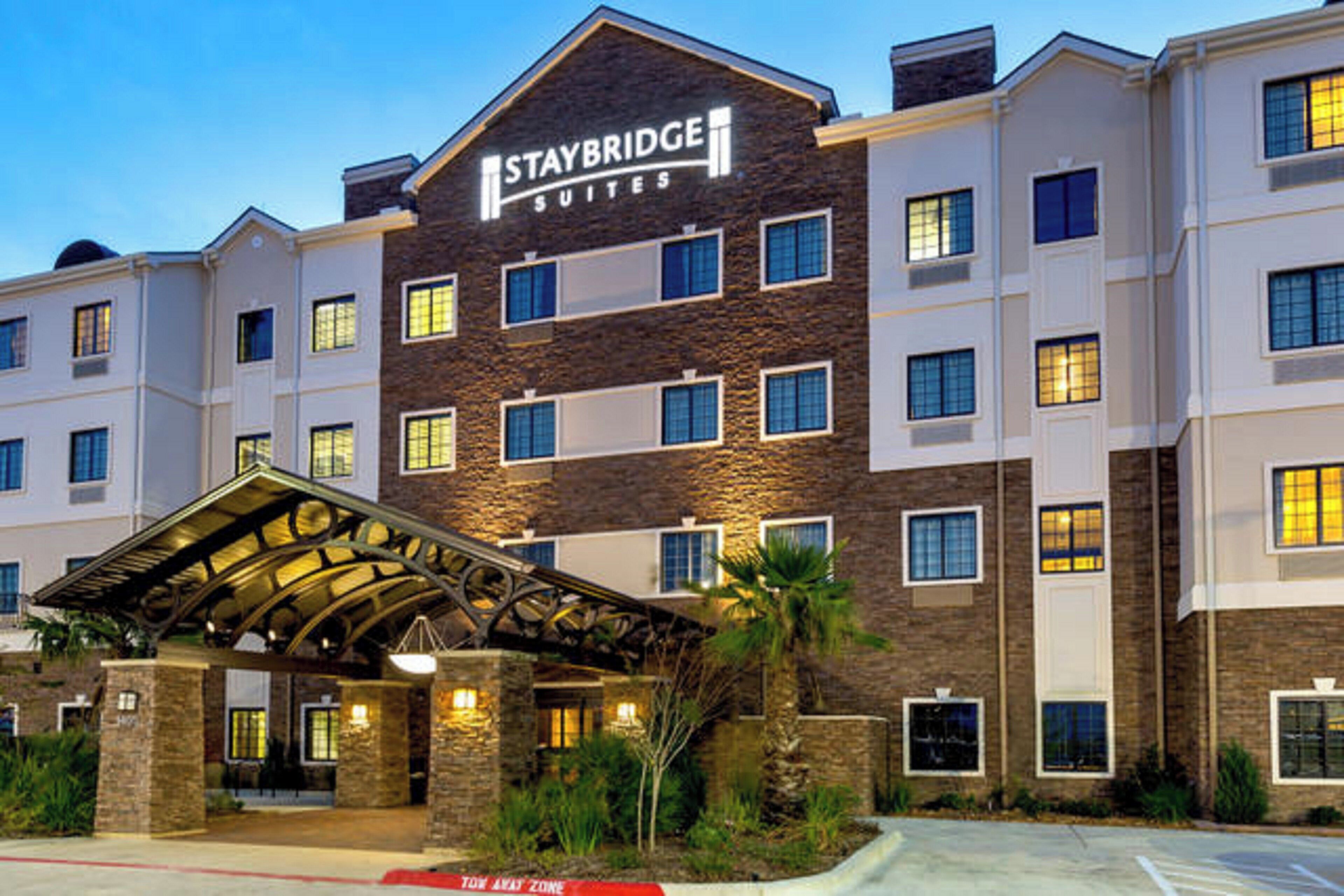 A Staybridge Suites hotel with a covered entrance and multiple floors.