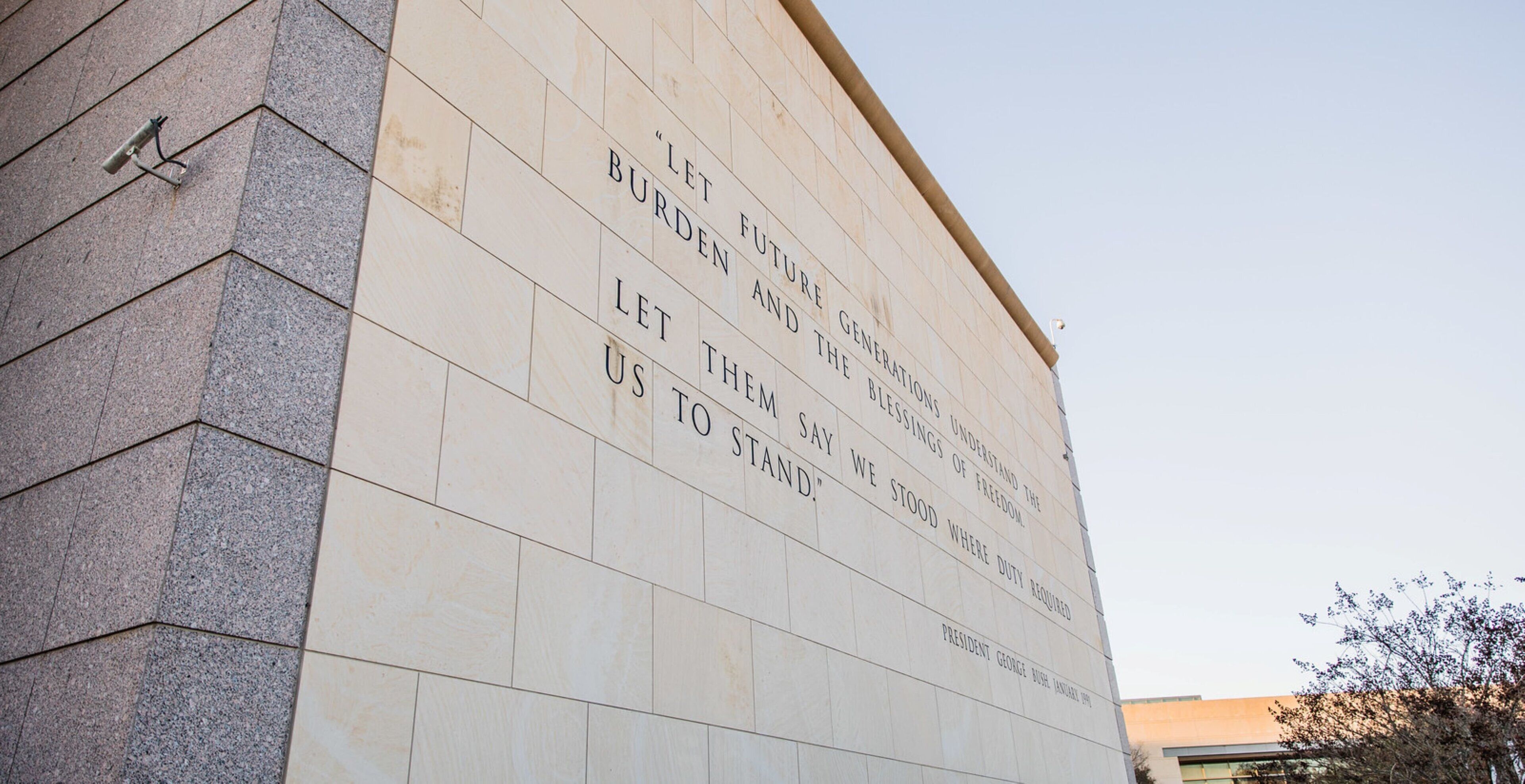 A building facade with a quote by President George Bush.