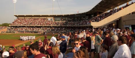 A stadium with tiered seating and a large crowd of spectators.