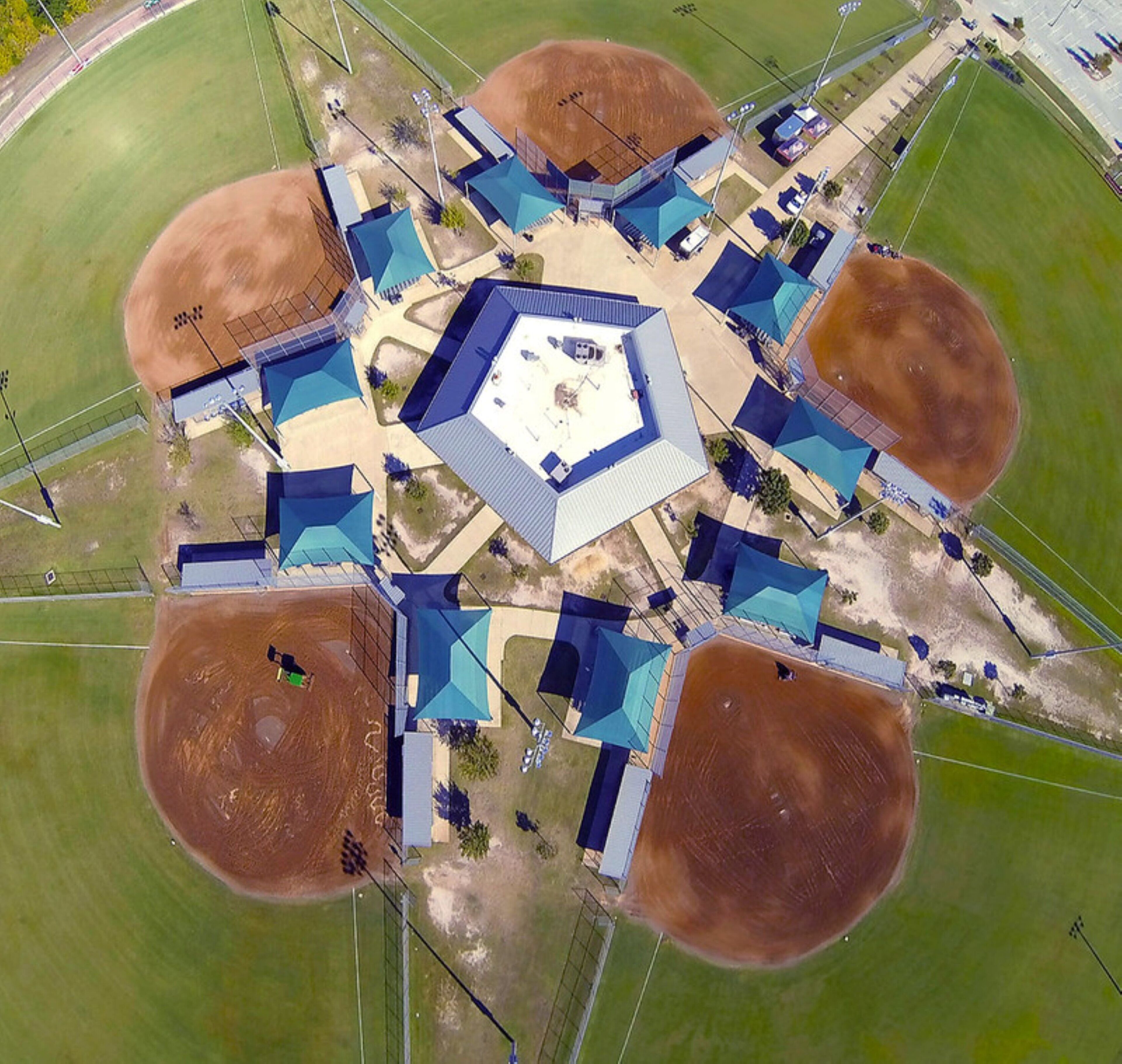 An aerial view of a baseball stadium with a central diamond, surrounding seating areas, and multiple dugouts.