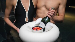 A round table with a white bowl containing strawberries and a bottle of champagne. - Hyatt Centric Milan Centrale (Milan)