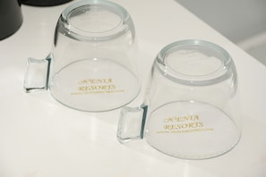 Two clear glass mugs with handles, each labeled 'XENIA RESORTS' and a website address.