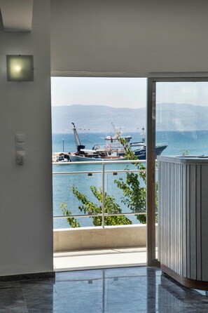 A modern interior with a large window overlooking a marina. - Porto Evia Boutique Hotel by Xenia Resorts (Eretria)