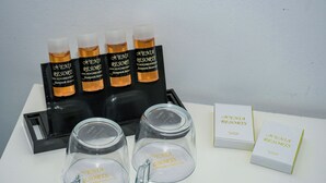 A display of toiletries including bottles and a glass jar with the branding 'Venia Resorts.' - Porto Evia Boutique Hotel by Xenia Resorts (Eretria)