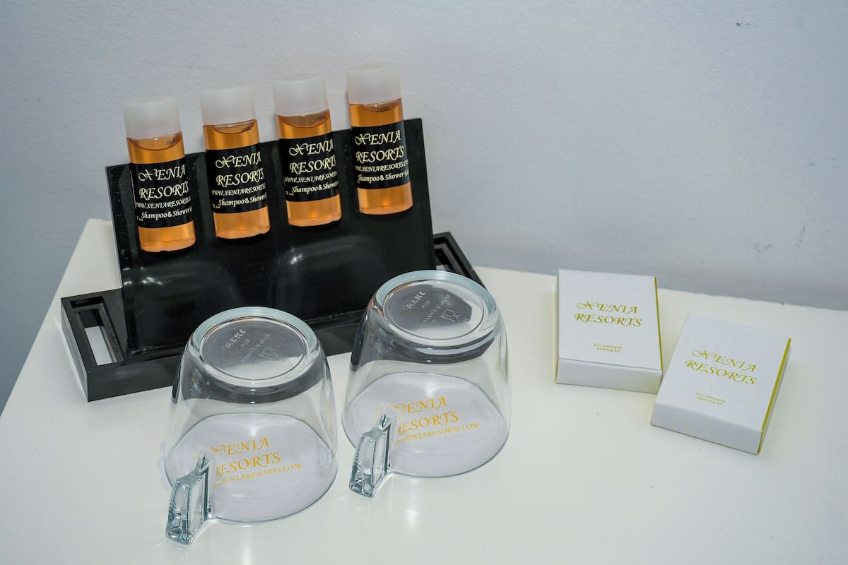 A display of toiletries including bottles and a glass jar with the branding 'Venia Resorts.'