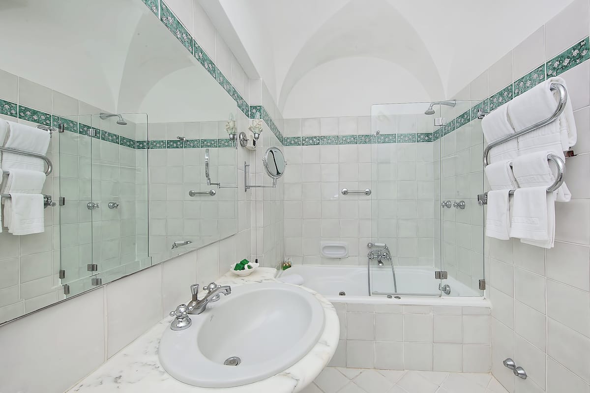 junior suite with patio and garden view | bathroom | free toiletries, hair dryer, slippers, towels