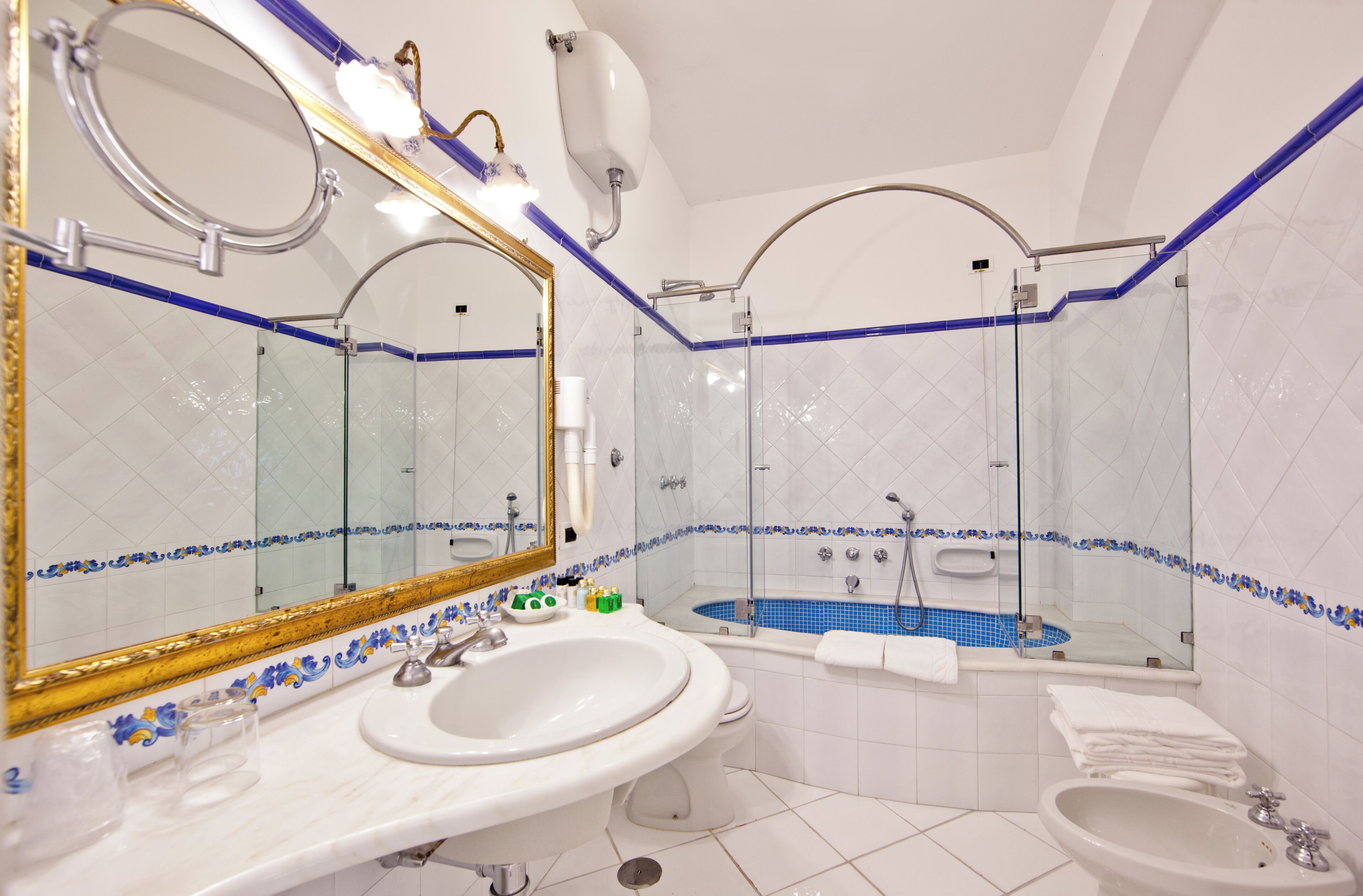 classic room with patio and garden view | bathroom | free toiletries, hair dryer, slippers, towels