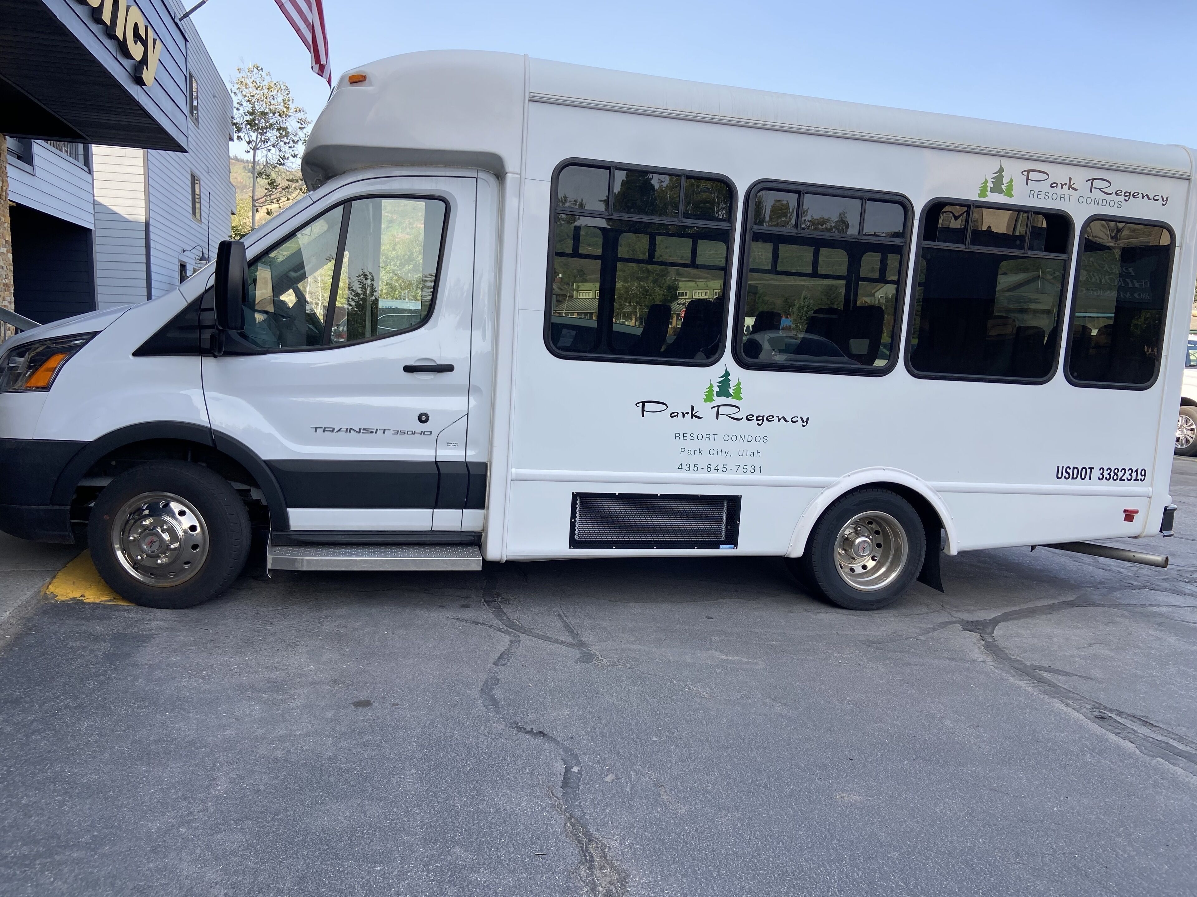 A white transit bus with the text "Park Regency Resort Condos" and "Park City, Utah" on its side.