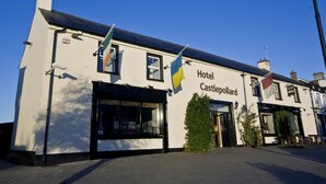 A building labeled "Hotel Castlepollard" with a clear blue sky in the background.