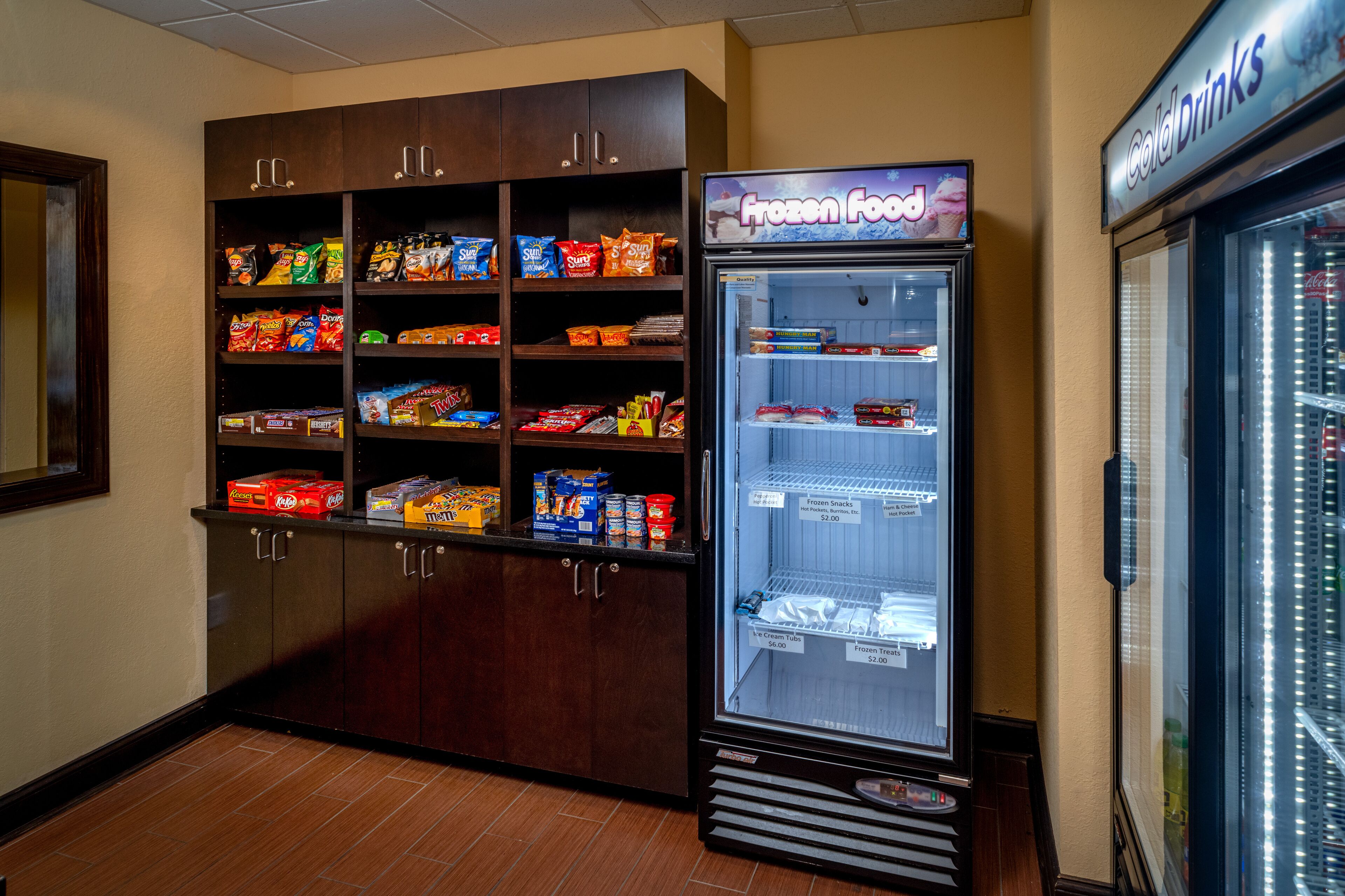A vending machine with a 'Frozen Food' sign, stocked with snacks and beverages.