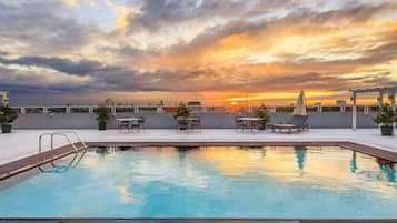 Relax by the pool surrounded by lush greenery and take in the serene views.