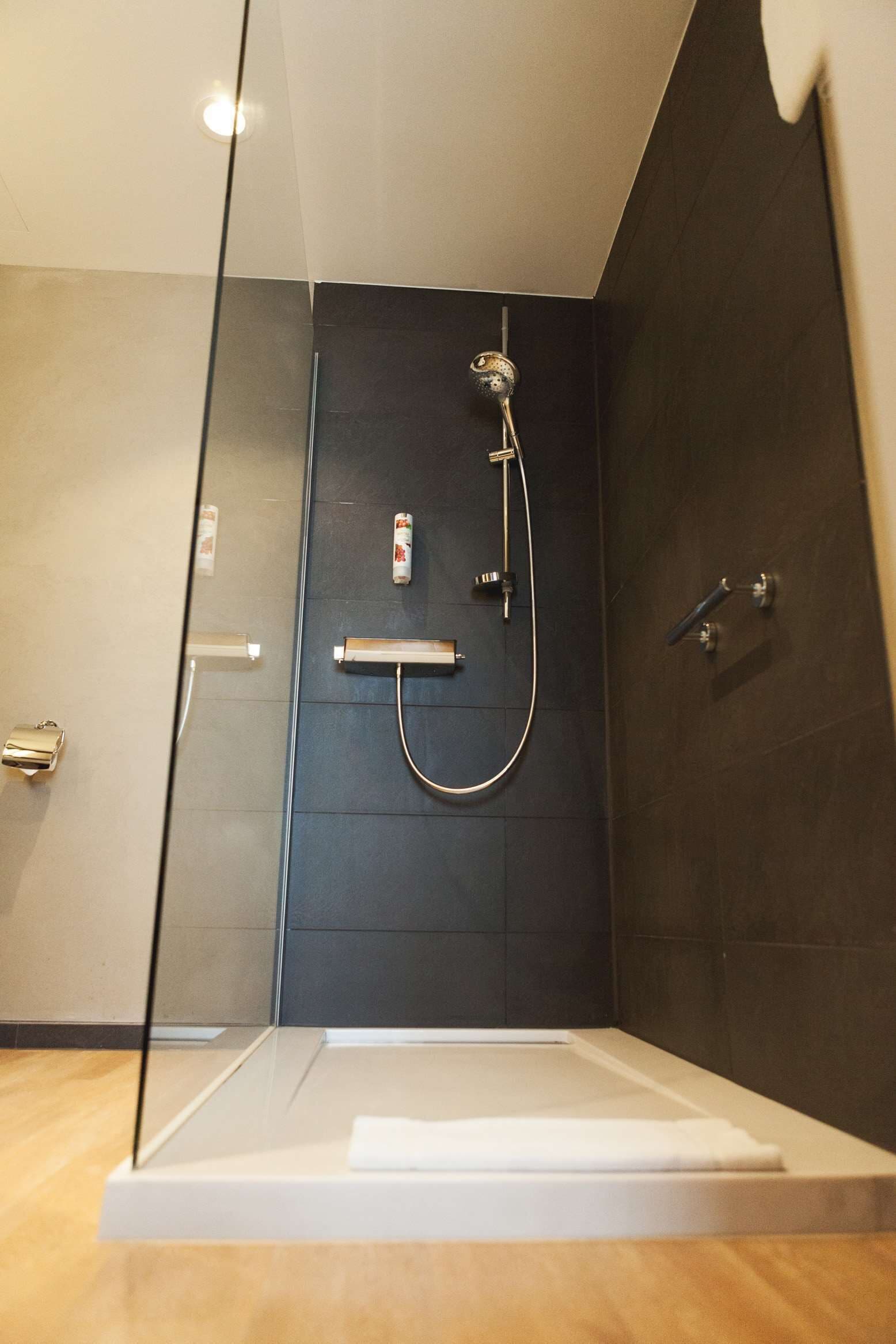 junior suite | bathroom | deep-soaking bathtub, designer toiletries, hair dryer, bathrobes