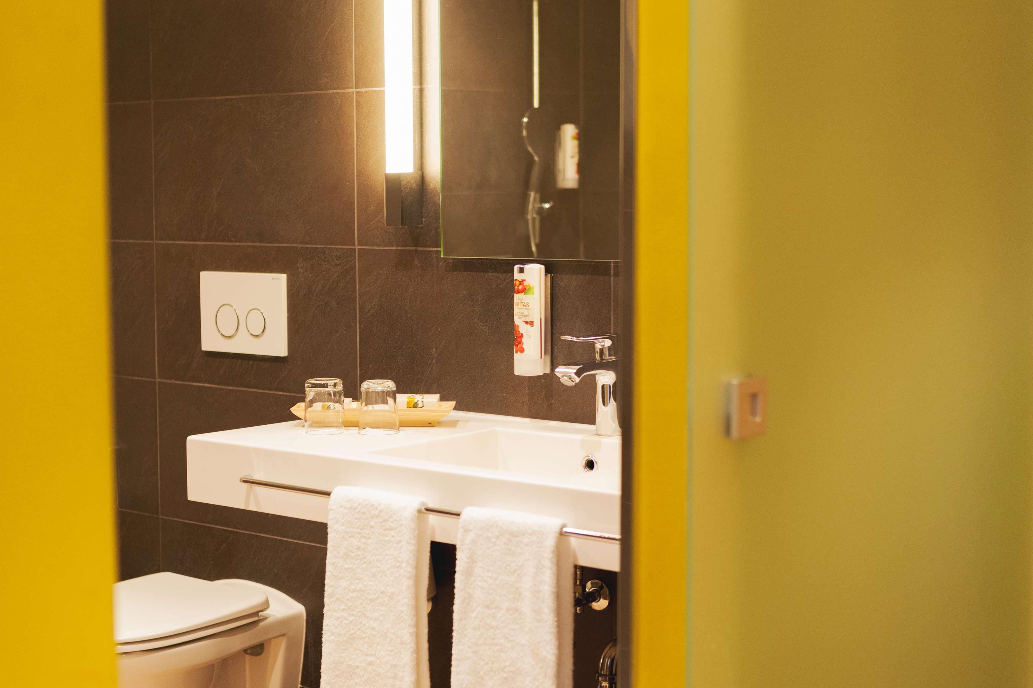 deluxe double room | bathroom | deep-soaking bathtub, designer toiletries, hair dryer, bathrobes
