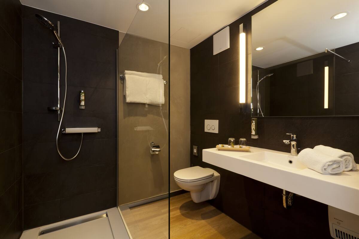 junior suite | bathroom | deep-soaking bathtub, designer toiletries, hair dryer, bathrobes
